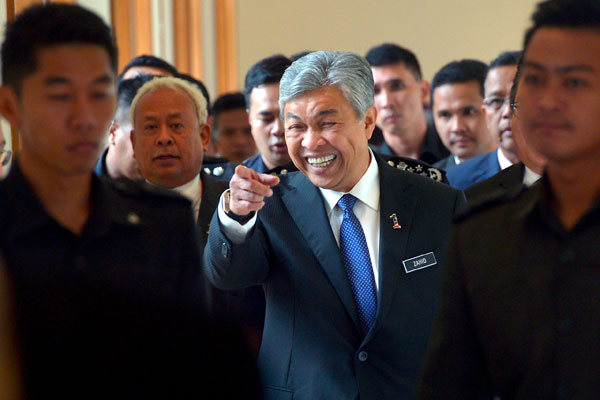 Zahid (centre) gestures after chairing a meeting on foreign workers and illegal immigrants at Putrajaya. — Bernama photo